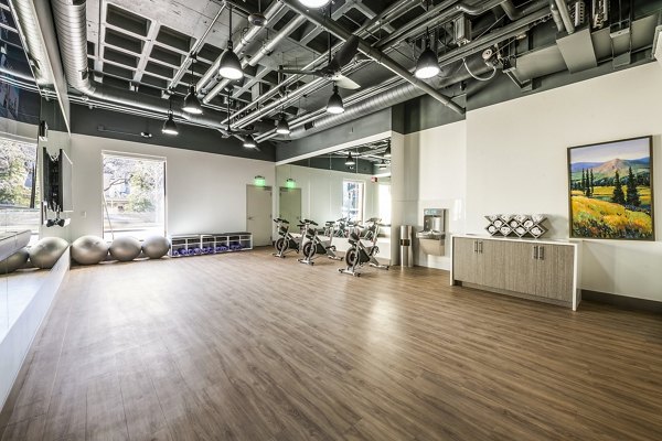 Bright yoga and spin studio with large mirrors at Eagle Gate Apartments, a luxury community by Greystar located in the heart of the city