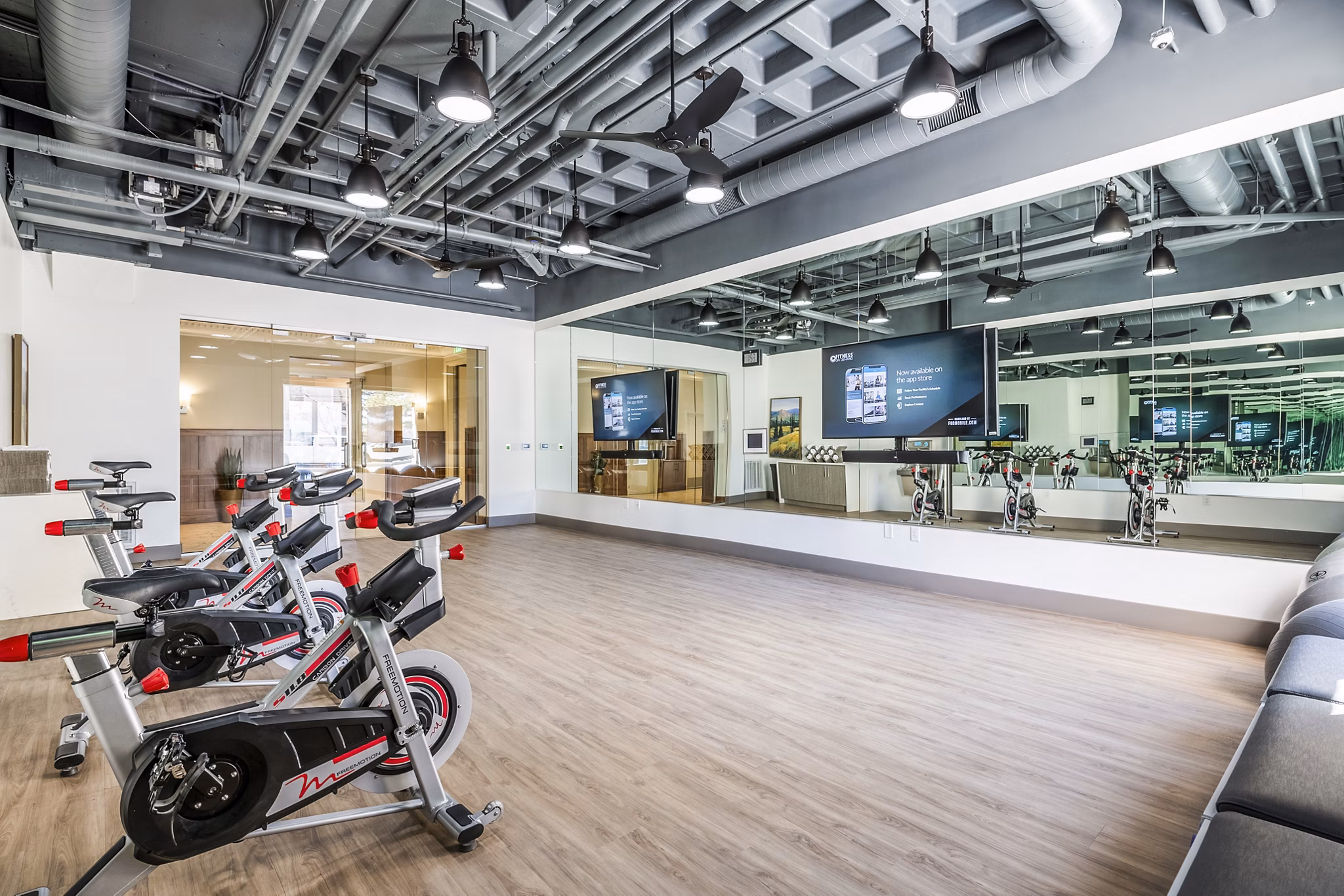 Modern yoga/spin studio with natural lighting at Eagle Gate Apartments, offering a tranquil environment for fitness enthusiasts