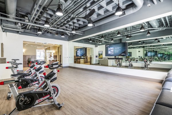Modern yoga/spin studio with natural lighting at Eagle Gate Apartments, offering a tranquil environment for fitness enthusiasts