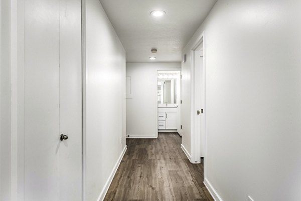 Hallway featuring modern lighting and art displays at Eagle Gate Apartments