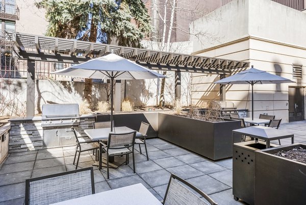 Outdoor patio with grill stations at Eagle Gate Apartments