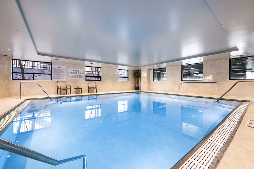 Luxurious pool area at Eagle Gate Apartments with modern design and comfortable lounge spaces for ultimate relaxation