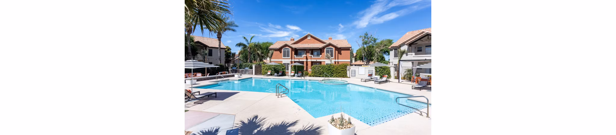 Luxurious pool area at Avana Coronado Apartments with elegant sun deck and lush landscaping