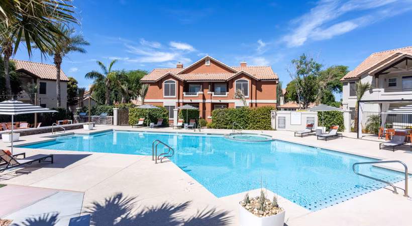 Luxurious pool area at Avana Coronado Apartments with elegant sun deck and lush landscaping