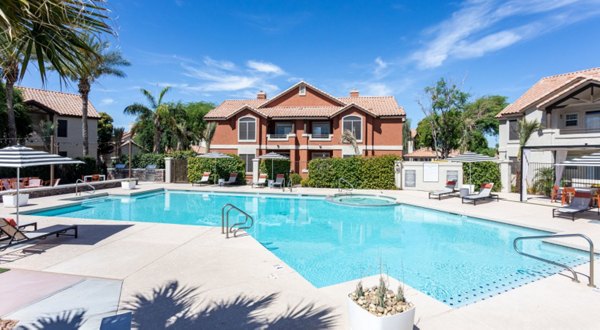 Luxurious pool area at Avana Coronado Apartments with elegant sun deck and lush landscaping