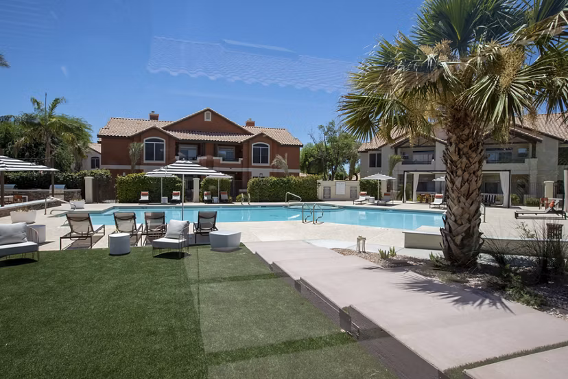Relaxing pool area with lounge chairs at Avana Coronado Apartments, a luxury living community