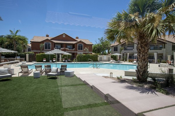 Relaxing pool area with lounge chairs at Avana Coronado Apartments, a luxury living community