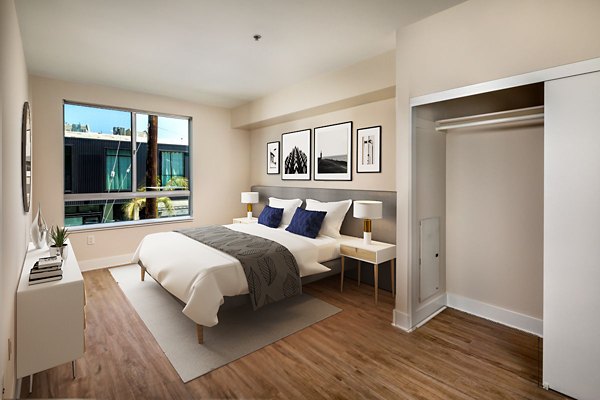 Bedroom with modern decor and ample natural light at Venice on Rose Apartments, part of Greystar luxury properties in Los Angeles