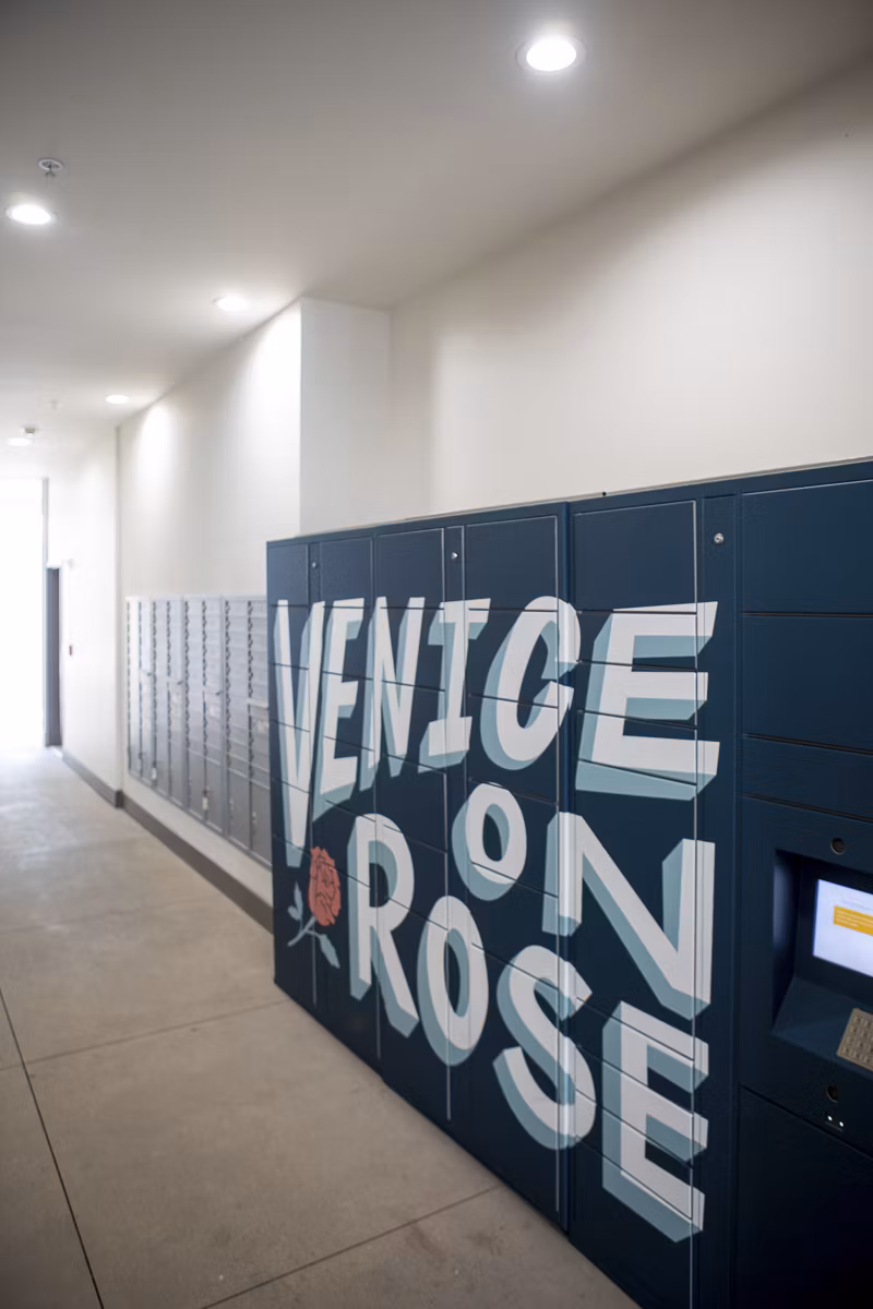 Modern mail room with secure package lockers at Venice on Rose Apartments, luxury living in Los Angeles