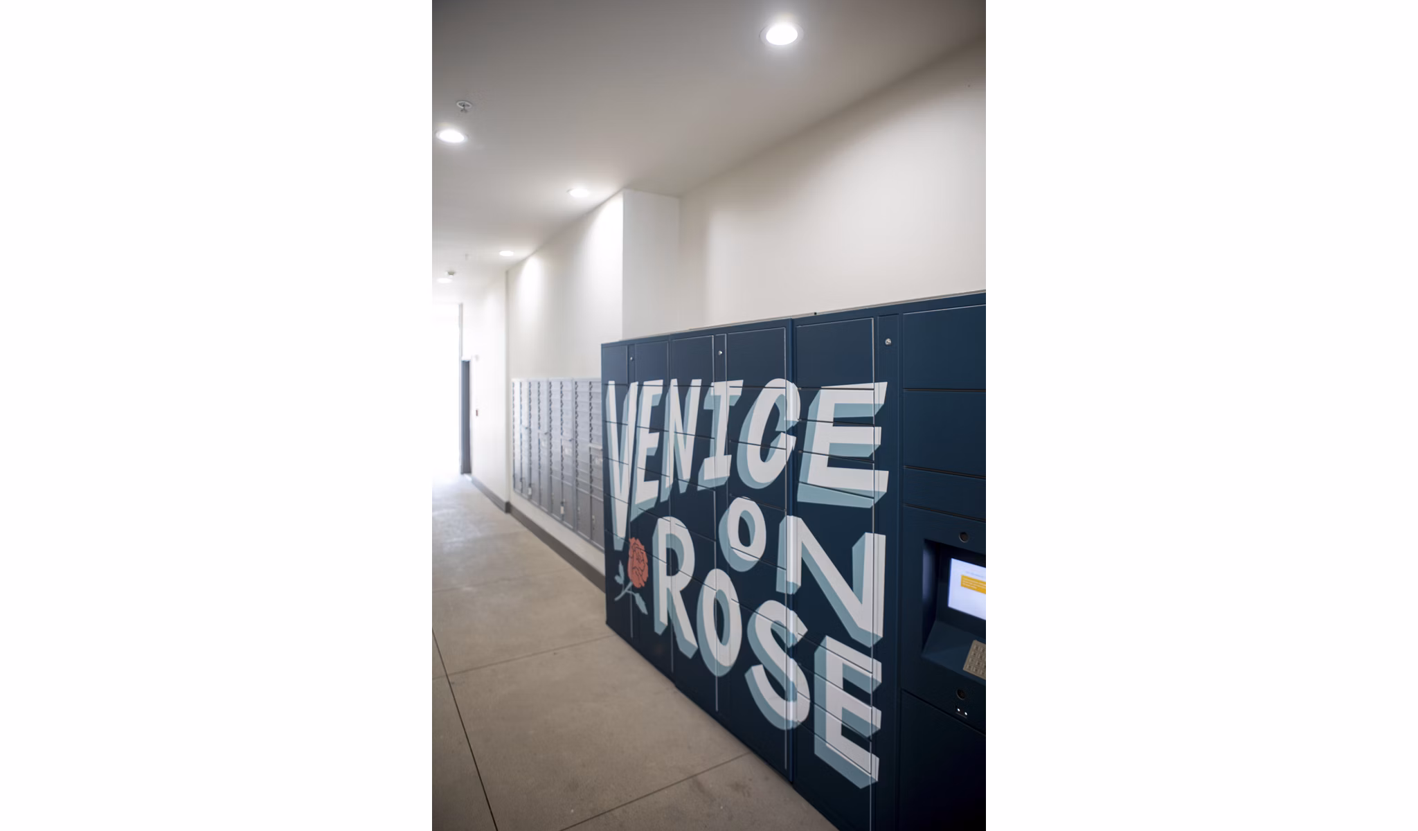 Modern mail room with secure package lockers at Venice on Rose Apartments, luxury living in Los Angeles