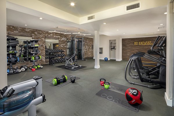 Fully equipped fitness center at Venice on Rose Apartments with state-of-the-art equipment and spacious workout areas