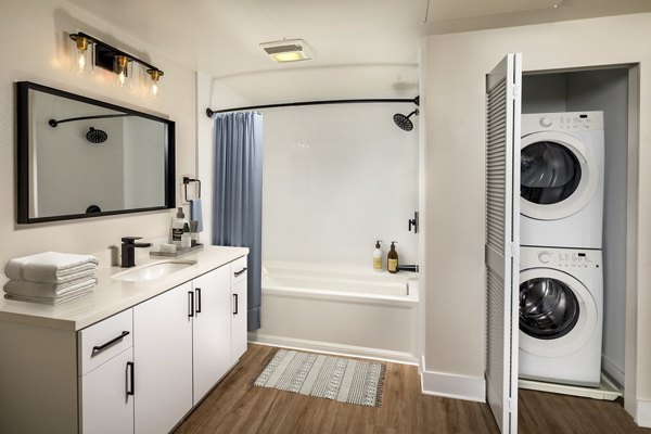 Bathroom featuring marble countertops and modern fixtures at Venice on Rose Apartments