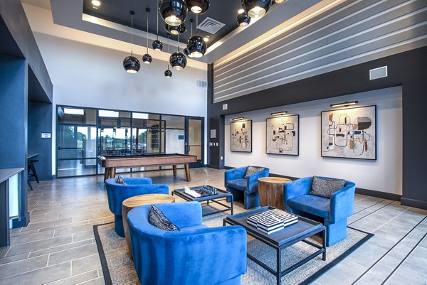 Modern game room with pool table and lounge seating at The Holston Apartments