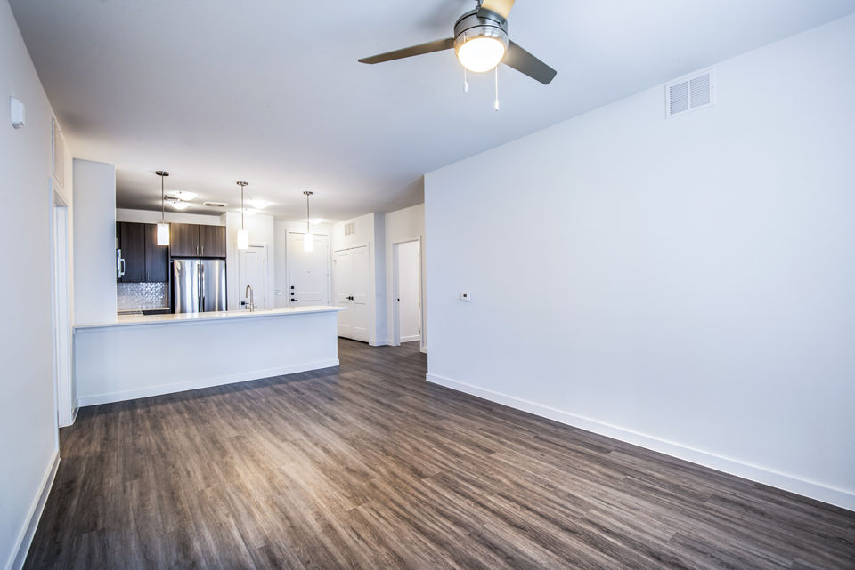 Spacious living room featuring modern decor and large windows in The Holston Apartments, luxury residences by Greystar