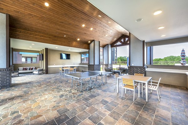 Grill area with modern seating on patio at The Holston Apartments, perfect for outdoor dining and relaxation in a luxury apartment community