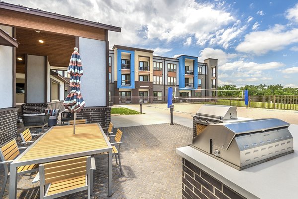 Outdoor grill area with modern seating at The Holston Apartments, ideal for socializing and dining al fresco