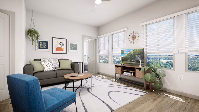 Modern living room with ample seating and natural light at Union on Frank Apartments, ideal for luxury living