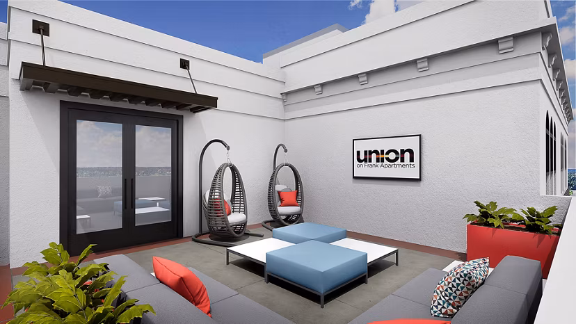 Chic outdoor patio with modern seating at Union on Frank Apartments
