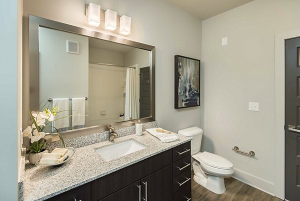 Modern bathroom featuring sleek fixtures and elegant tile work in Leigh House Apartments