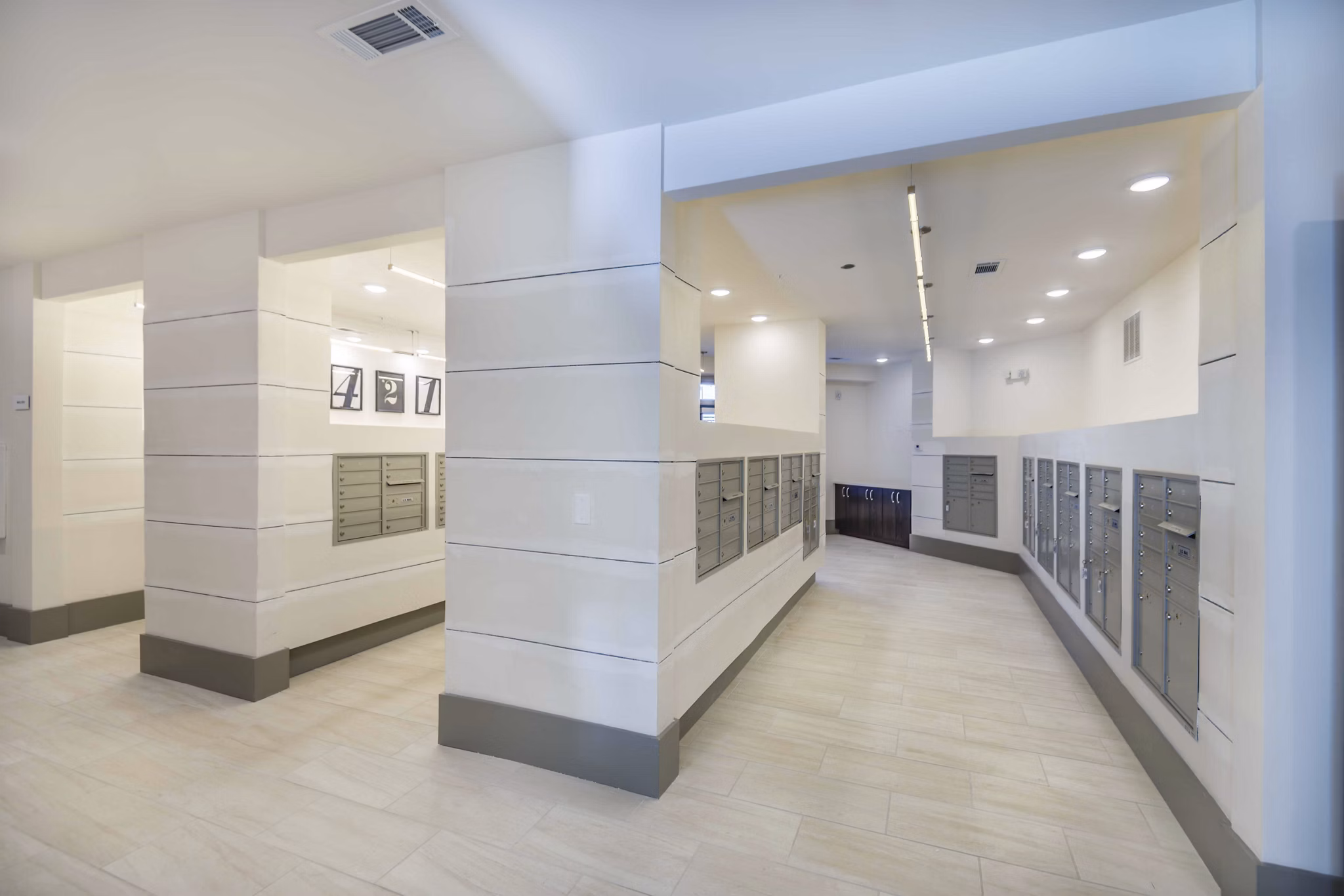 Mail room with modern design and secure package lockers at Leigh House Apartments