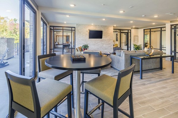 Modern clubhouse featuring a cozy lounge and elegant decor at Leigh House Apartments