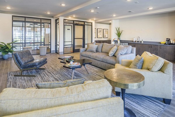 Leigh House Apartments: Modern clubhouse featuring cozy seating and gaming areas