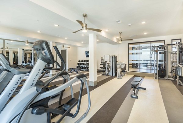 Modern fitness center with state-of-the-art equipment at Leigh House Apartments, perfect for active lifestyles in a luxury setting