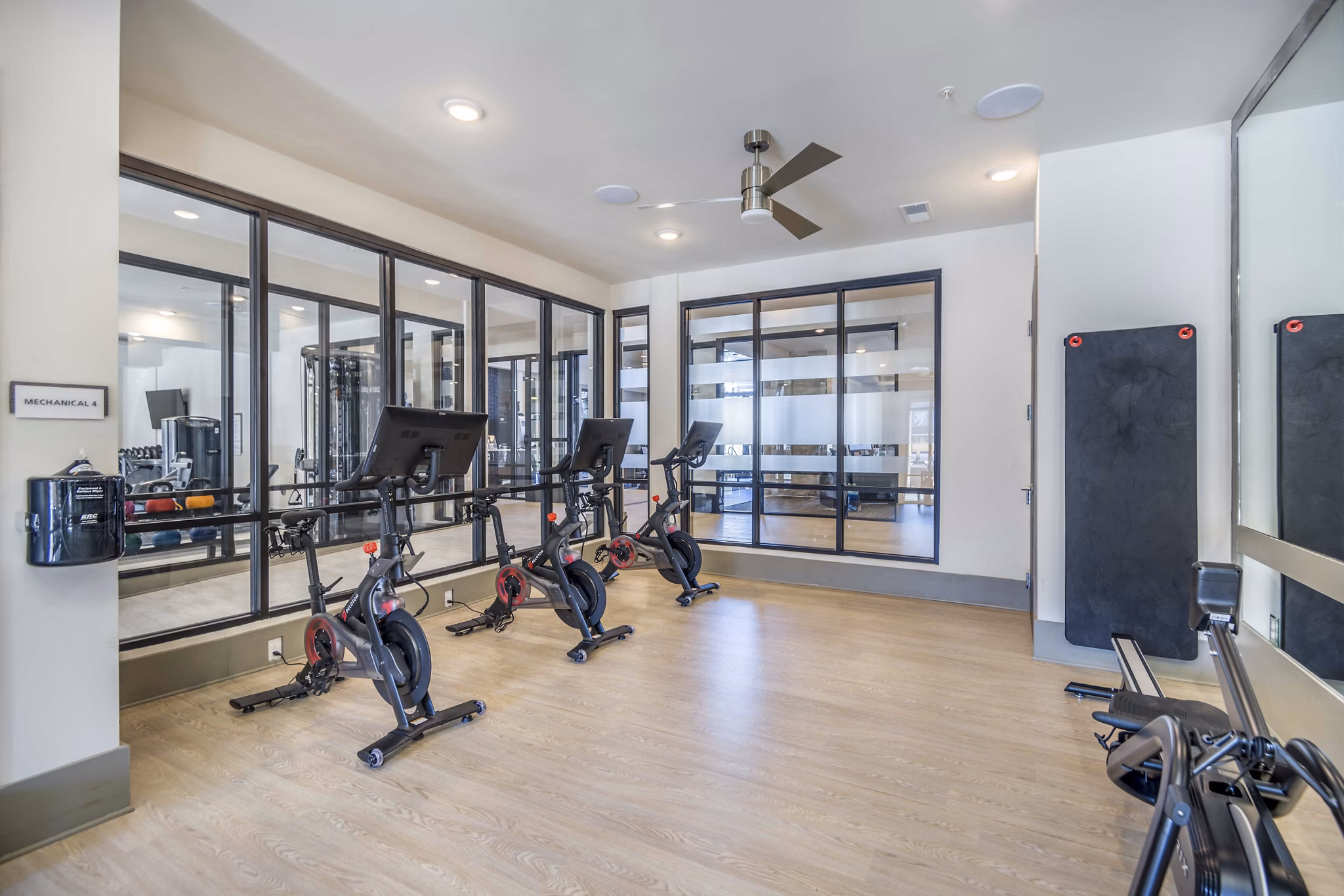 Yoga and spin studio featuring modern equipment at Leigh House Apartments