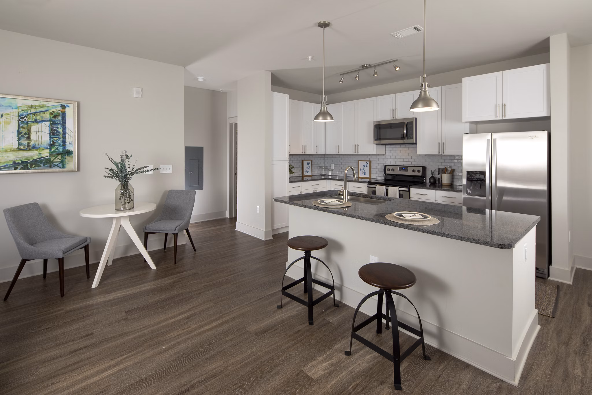 Modern kitchen featuring stainless steel appliances and granite countertops at Leigh House Apartments
