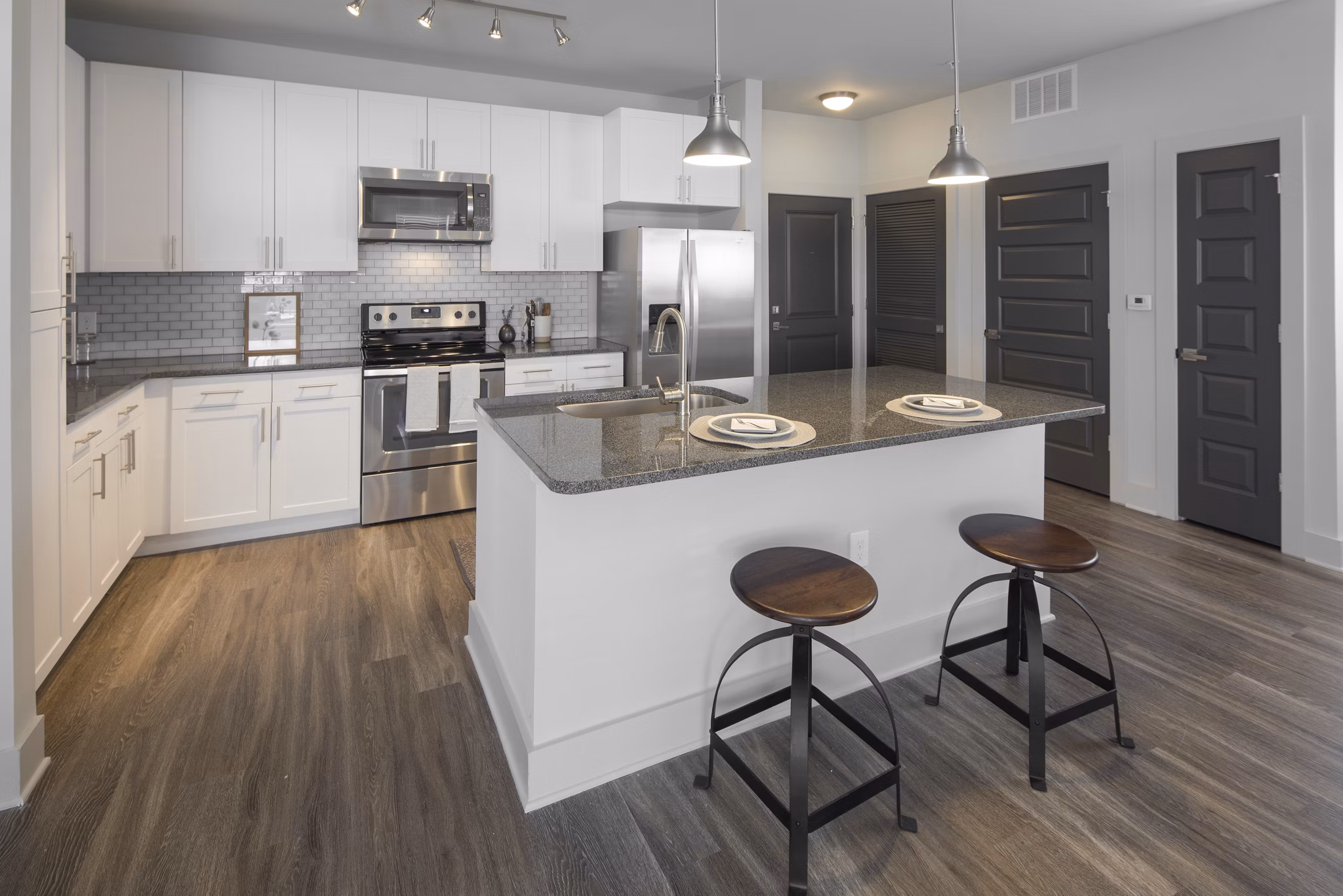 Modern kitchen with stainless steel appliances in Leigh House Apartments