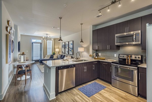 Modern kitchen with sleek countertops and stainless steel appliances at Leigh House Apartments
