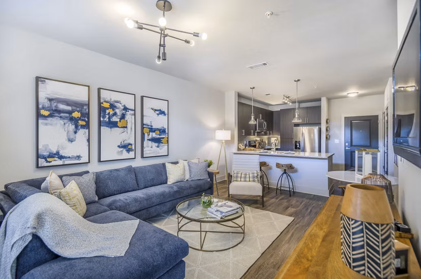 Living room with modern decor and large windows at Leigh House Apartments - luxury living in a prime location