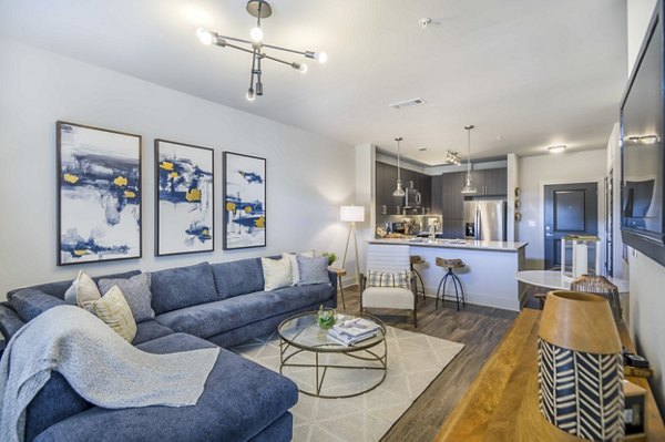 Living room with modern decor and large windows at Leigh House Apartments - luxury living in a prime location