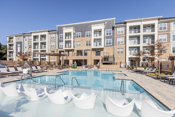 Luxurious poolside retreat at Leigh House Apartments with modern seating and greenery