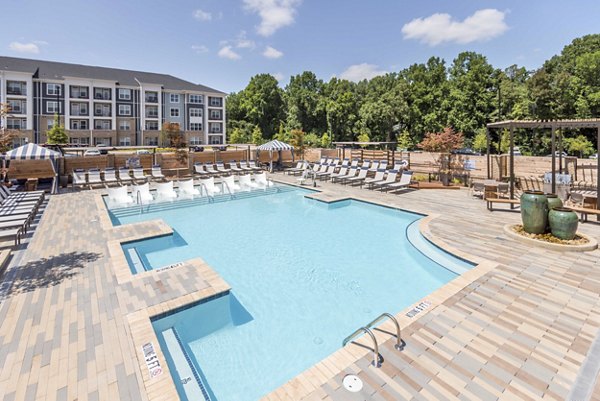 Rooftop pool with lounge chairs at Leigh House Apartments offering luxury living and city views