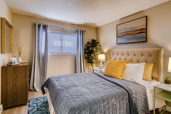 Spacious bedroom featuring modern design and large windows at Arterra Apartments