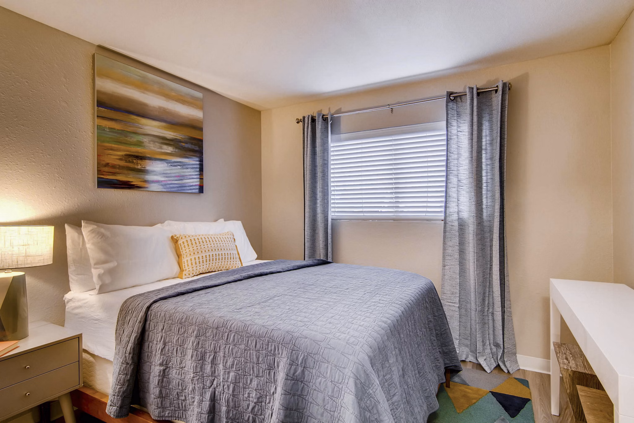 Cozy bedroom with modern furnishings at Arterra Apartments