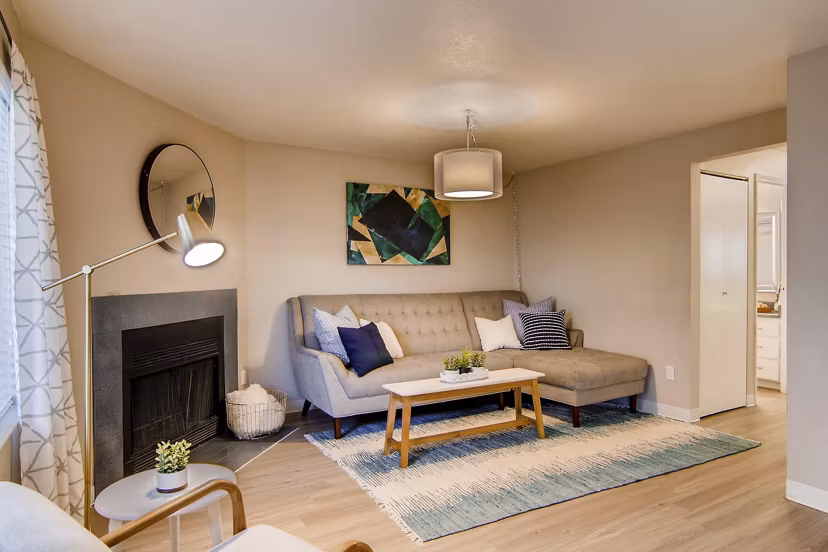 Living room featuring modern decor and large windows at Arterra Apartments