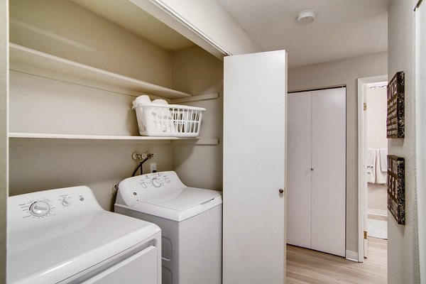 Laundry room featuring modern appliances in Arterra Apartments