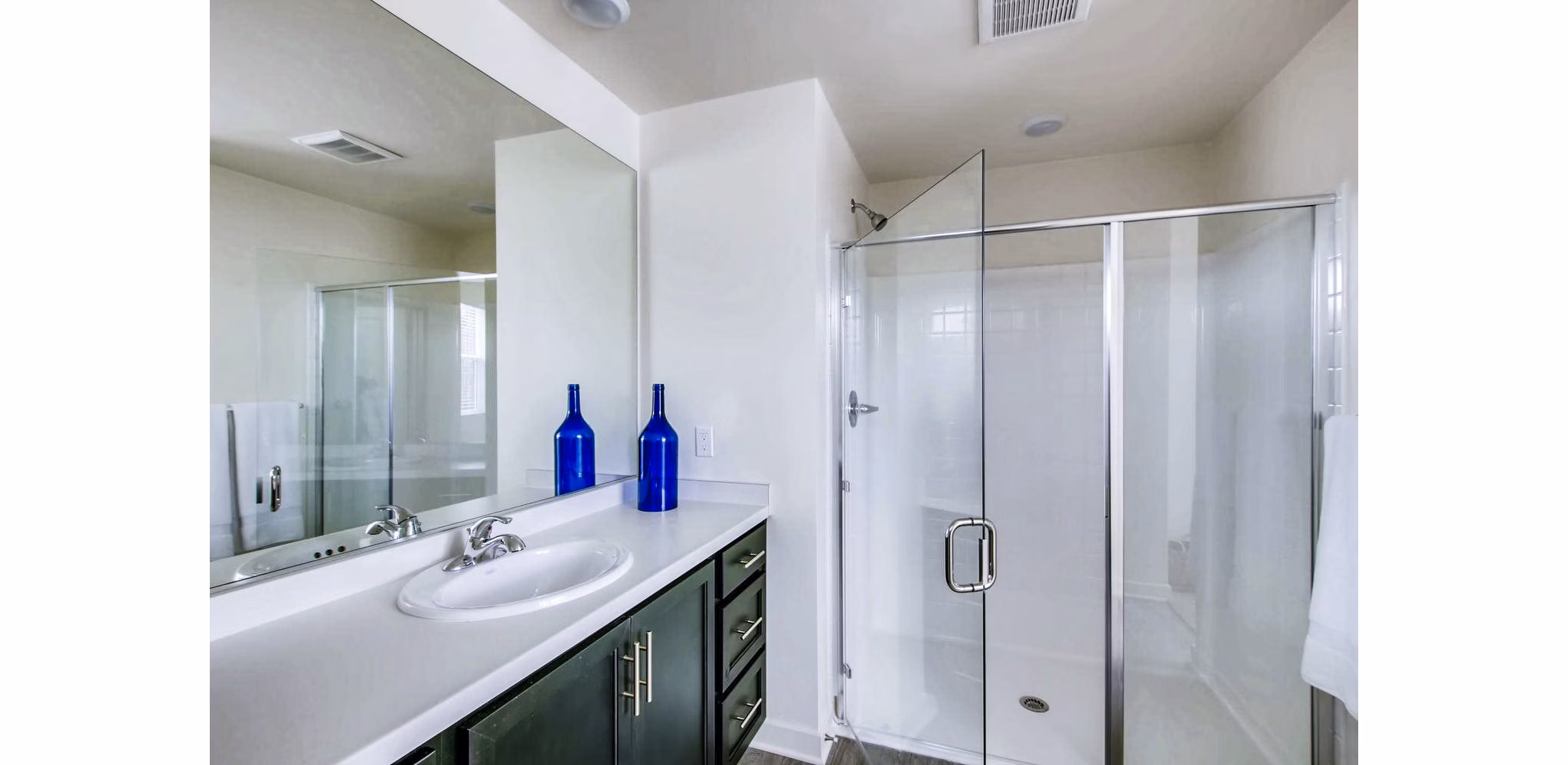 Modern bathroom with sleek fixtures and marble accents at Ascent at Campus of Life Apartments