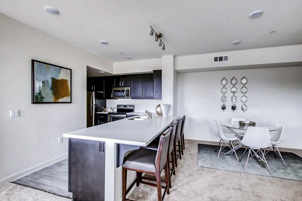 Dining area with modern furnishings and natural lighting at Ascent at Campus of Life Apartments