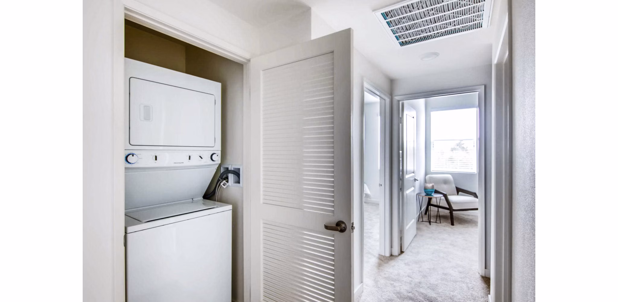 Laundry area with energy-efficient machines in Ascent at Campus of Life Apartments
