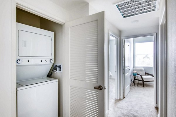 Laundry area with energy-efficient machines in Ascent at Campus of Life Apartments
