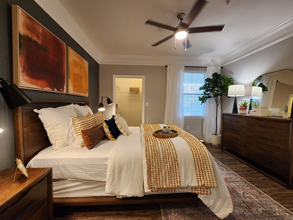 Cozy bedroom with neutral tones and abundant natural light in Grand Villas at Tuscan Lakes Apartments