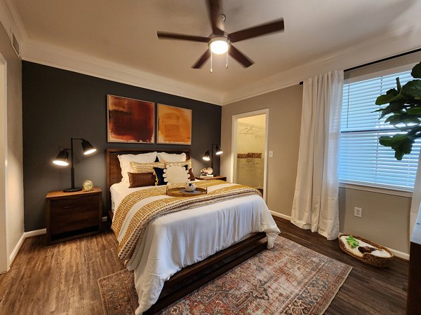Cozy bedroom with modern furnishings at Grand Villas at Tuscan Lakes Apartments