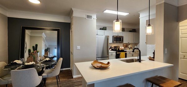 Modern kitchen with stainless steel appliances at Grand Villas at Tuscan Lakes Apartments