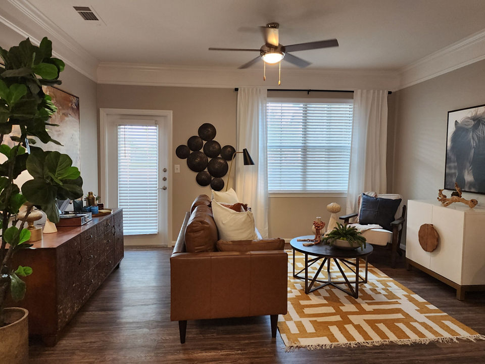 Spacious living room with modern decor in Grand Villas at Tuscan Lakes Apartments