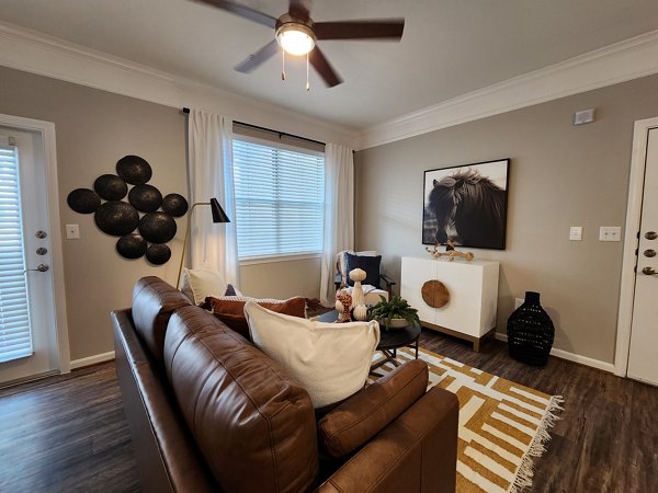 Living room featuring modern decor and ample natural light in Grand Villas at Tuscan Lakes Apartments, perfect for luxury living