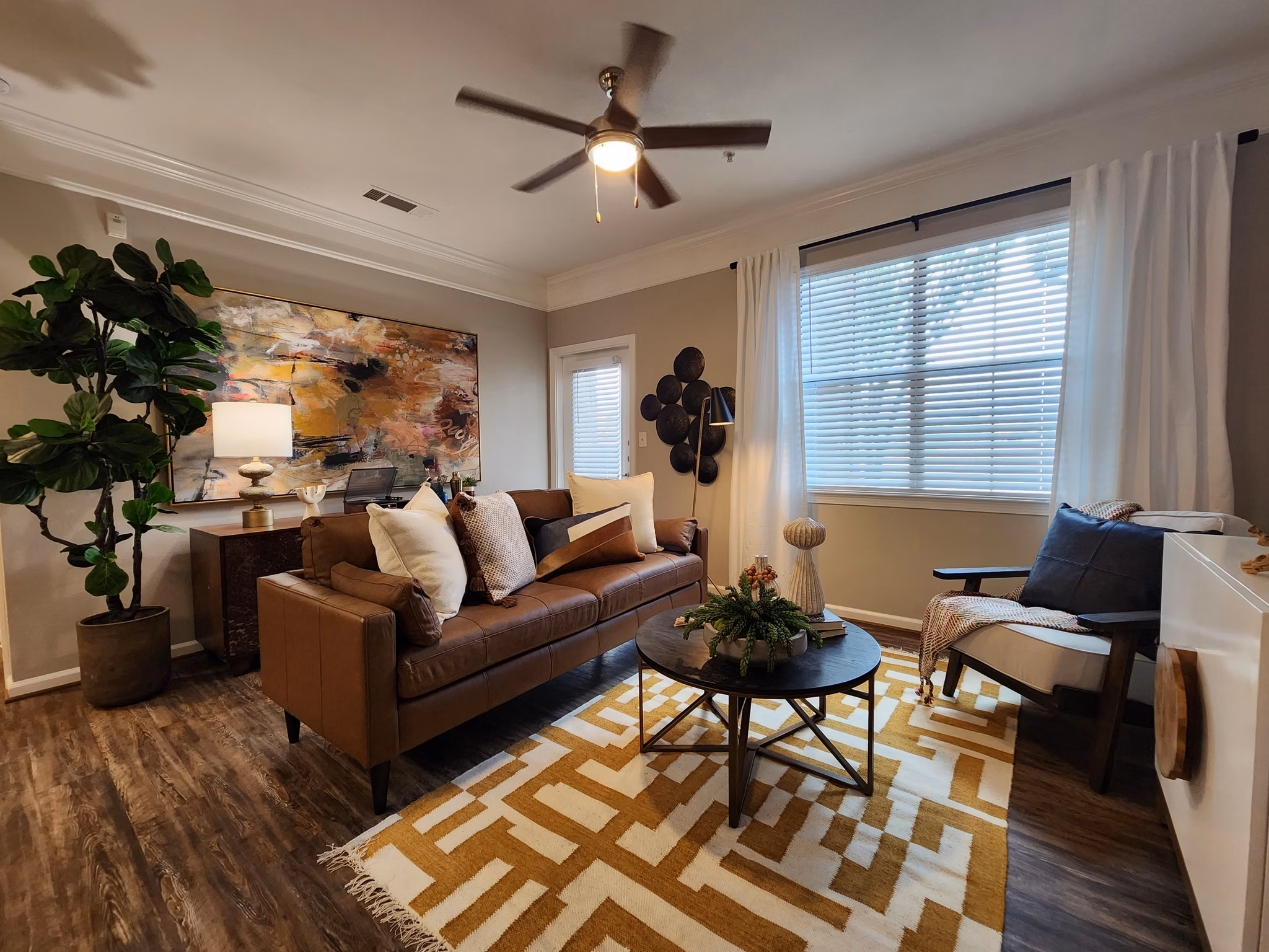 Cozy living room with plush seating in Grand Villas at Tuscan Lakes Apartments