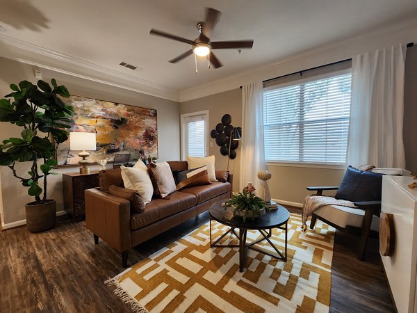 Cozy living room with plush seating in Grand Villas at Tuscan Lakes Apartments